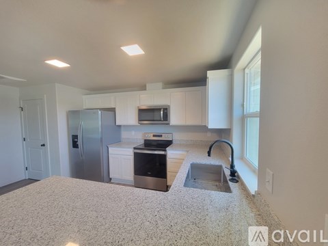 A kitchen with a sink and a refrigerator.