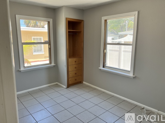 A room with a door, a window, and a tiled floor.