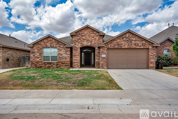 A house with a garage and a driveway in front.