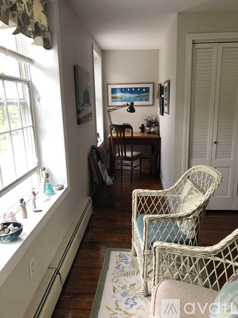 A living room with a chair and a table.