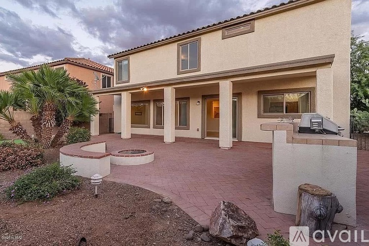A house with a front yard and a palm tree.