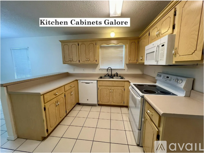 A kitchen with wooden cabinets and white appliances.
