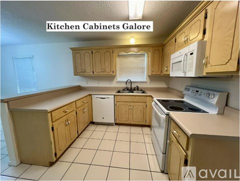 A kitchen with wooden cabinets and white appliances.