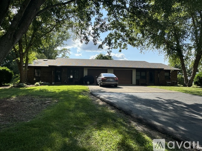 A house with a car parked in front of it.