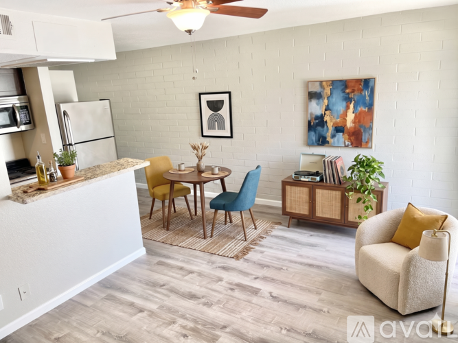 A kitchen with a dining table and chairs.