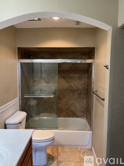 A bathroom with a toilet, sink, and shower.