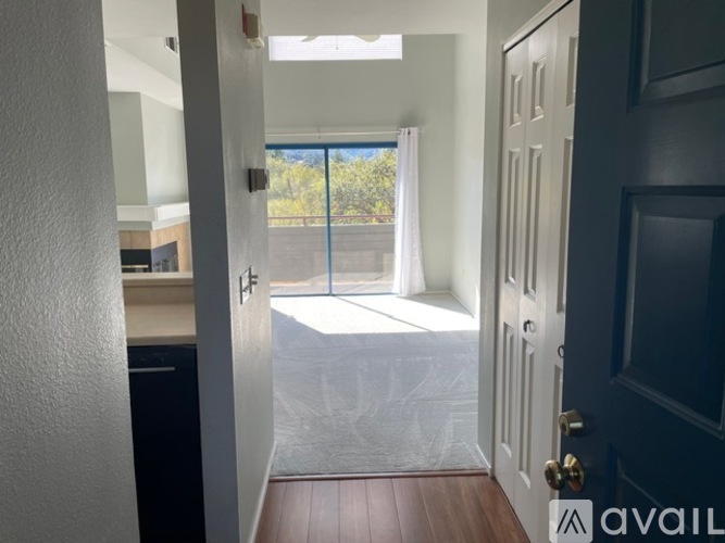 A hallway with a door leading to a balcony.