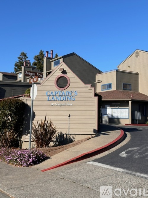 A building with a sign that says Captain's Landing.
