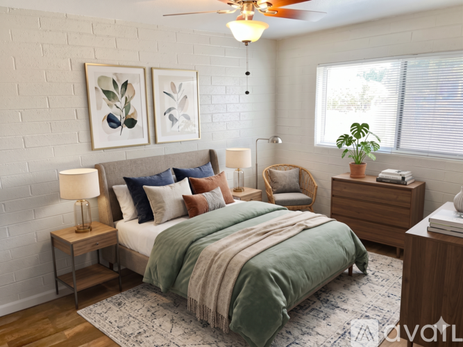 A bedroom with a bed, nightstand, and a ceiling fan.