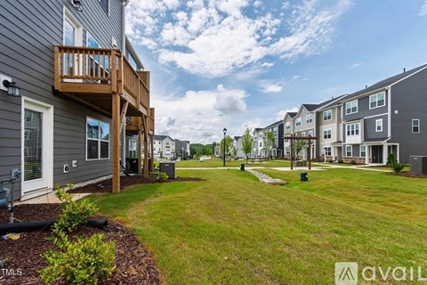 A row of houses with a grassy area in the foreground.