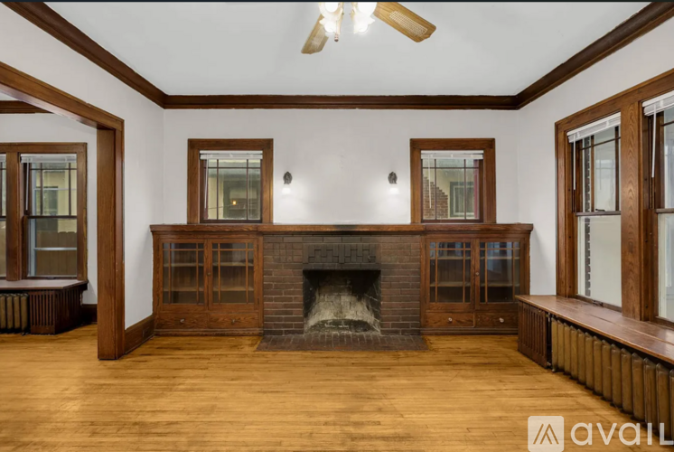 A living room with a fireplace and wood floors.