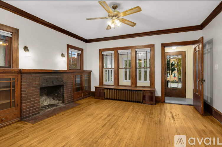 A living room with wood floors and a fireplace.