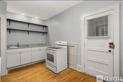 A kitchen with white appliances and cabinets.