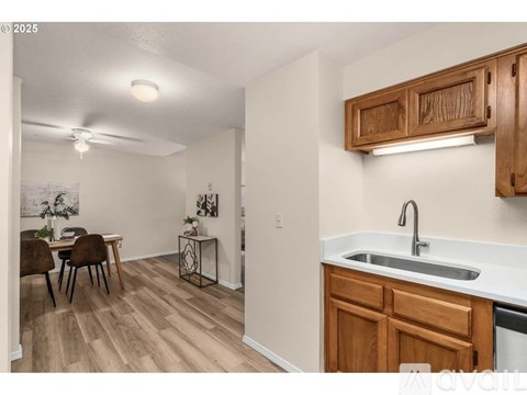 A kitchen with wooden cabinets and a white countertop.