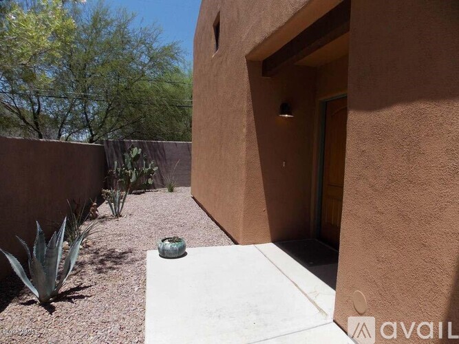 A small courtyard with a wall and a doorway.