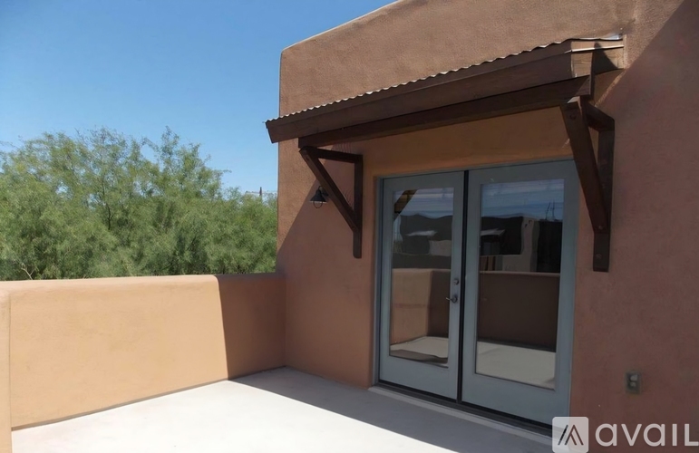 A tan building with a glass door and window.