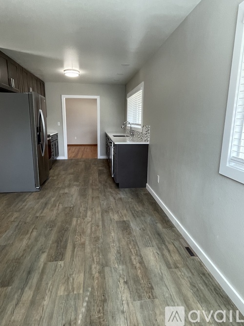 A kitchen with a refrigerator and a countertop.