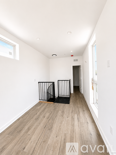 A room with wooden floors and white walls.