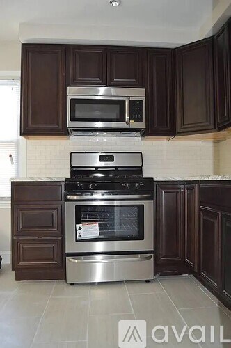 A kitchen with a stove, oven, and microwave.