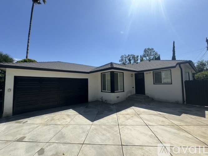 A house with a black garage door and a white exterior.