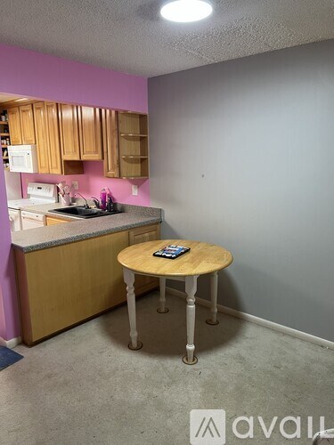 A kitchen with a table and a counter.