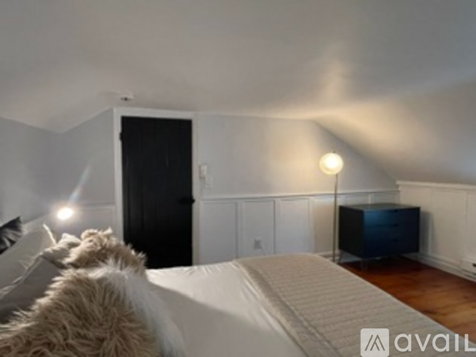 A bedroom with a bed, a television, and a cabinet.