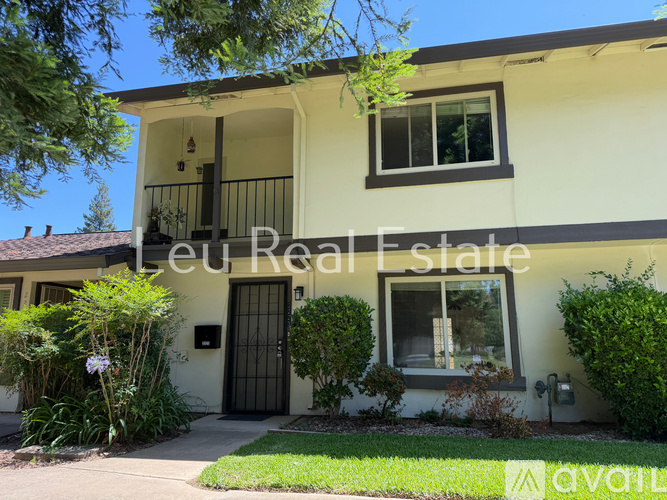 A house with a balcony and a door is for sale.