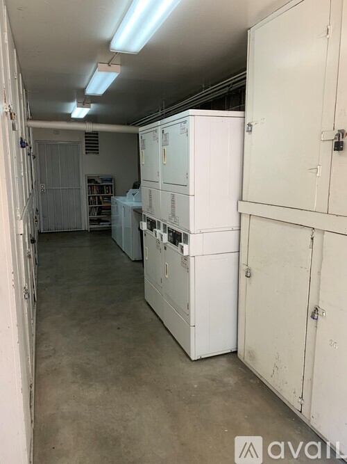 A room with white cabinets and a concrete floor.
