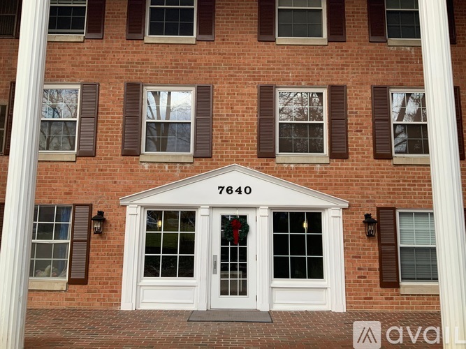 A red brick building with the number 7640 on the front door.