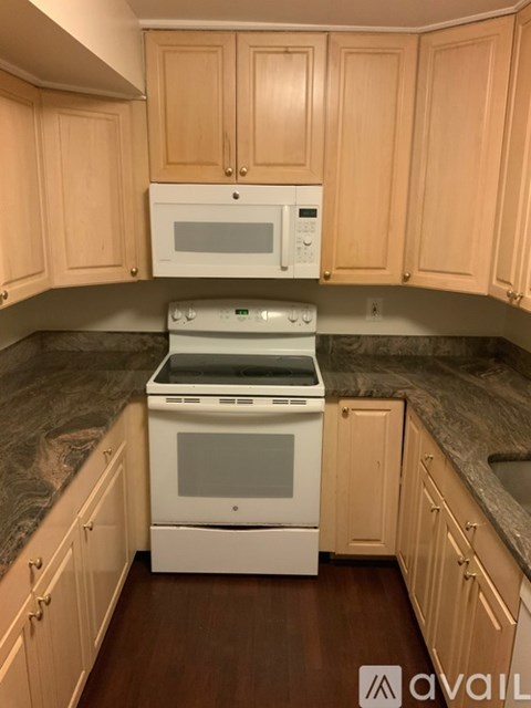 A kitchen with wooden cabinets and a white oven.