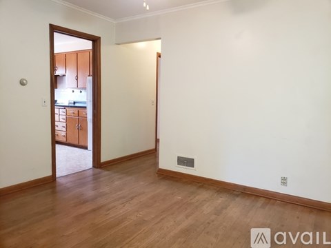 A dining room with a table and chairs.