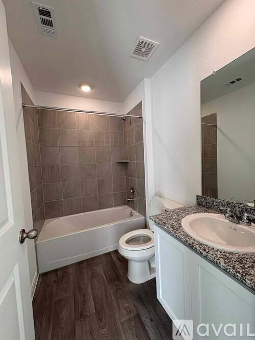 A bathroom with a toilet, sink, and bathtub.