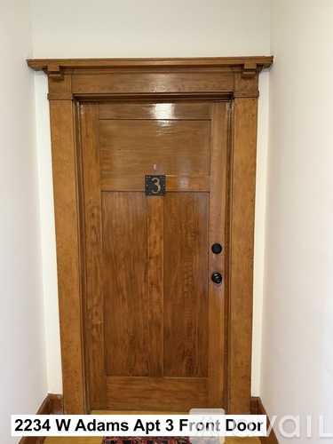A brown wooden door with a black handle and a number 3 on the top.