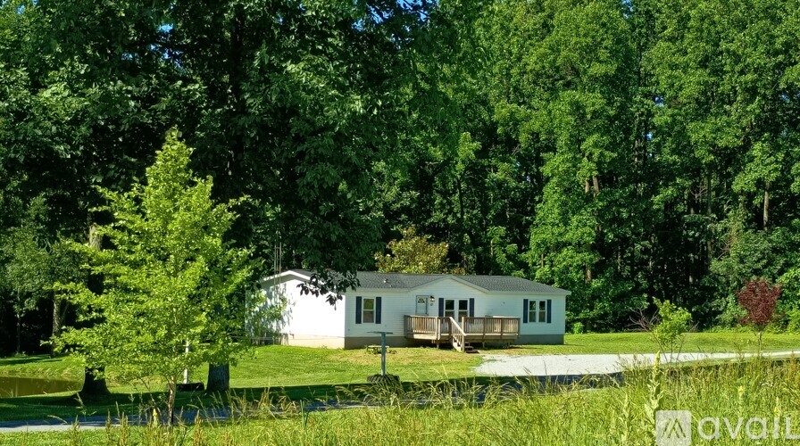 A house is surrounded by trees and grass.