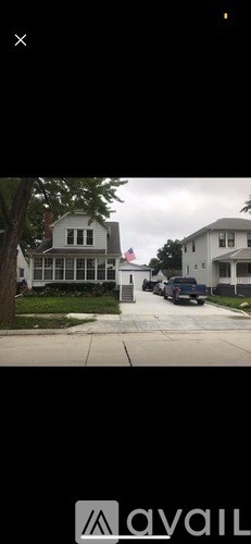 A white house with a flag on the front.