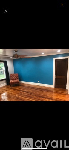 A room with blue walls and wooden floors.