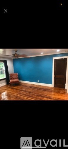 A room with blue walls and wooden floors.