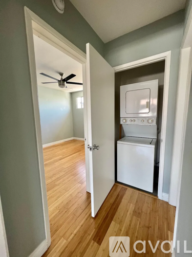 A kitchen with a white oven and a fan on the ceiling.