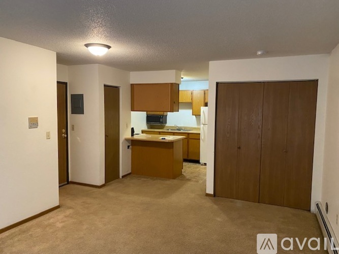 A kitchen area with brown cabinets and a countertop.