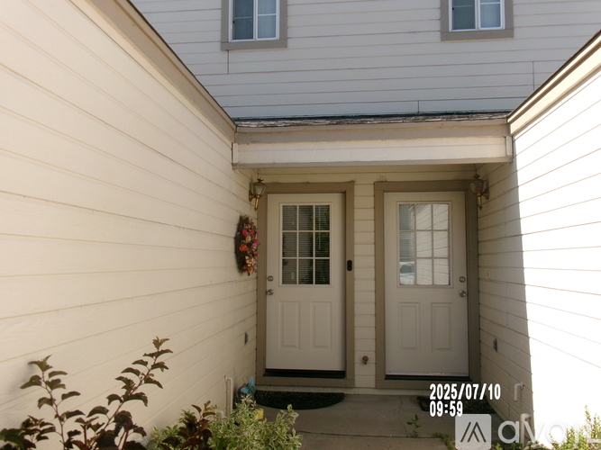 A house with a white door and a window above it.