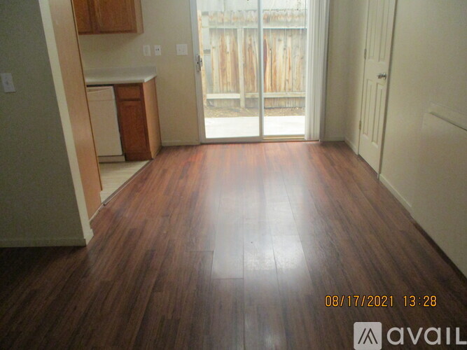A room with wooden floors and a white door.