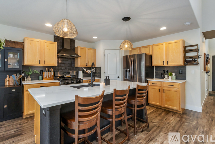 A kitchen with wooden cabinets and a white island.