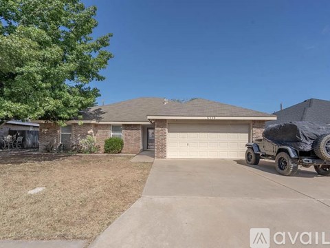 A house with a garage and a truck parked in front.