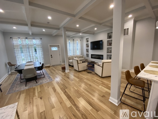 A living room with wooden floors and furniture.