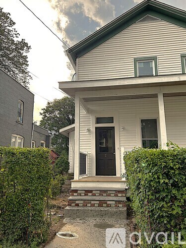 A white house with a black door and windows.