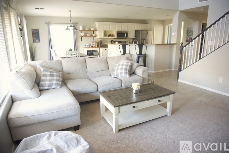 A living room with a white couch and a coffee table.