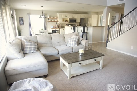 A living room with a white couch and a coffee table.