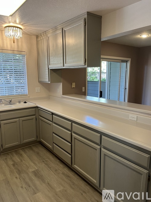 A kitchen with a countertop and cabinets.