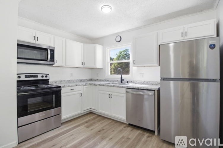 A kitchen with white cabinets and stainless steel appliances.