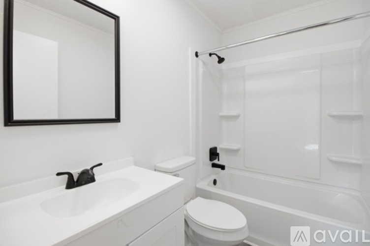 A bathroom with a white sink, toilet and bathtub.